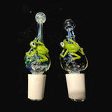 Two hand blown glass frog wine stoppers by Chris Barclay, sculpted green frogs on clear bulbs of Experimental Green #5 and cobalt frit