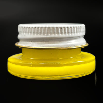Empty 1 threaded glass jar in canary yellow with its white metal screw lid on, side view