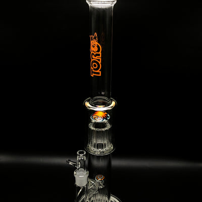 Toro 7/13 arm tube standing full height on black, orange Toro logo on the clear neck.
