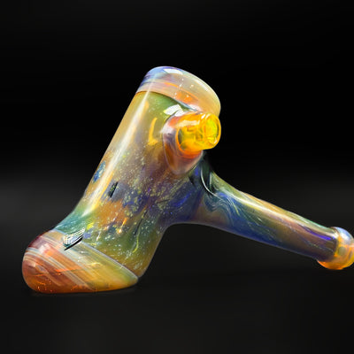 Fumed space hammer pipe by @itsnotawaterpipe, three-quarter view showing the Amber Purple carb and the fumed can