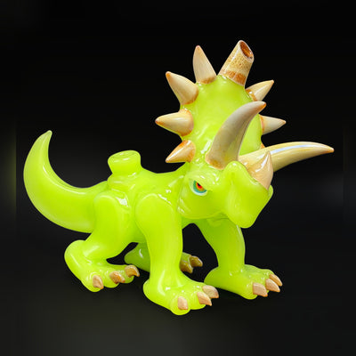 Nerv Glass triceratops rig, a sculpted lime green triceratops with a spiked frill and bronze horns, seen from the side