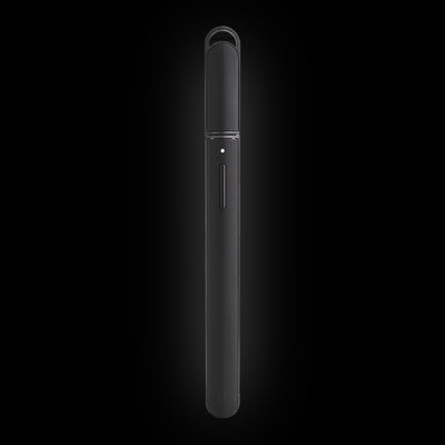 Puffco Hot Knife in Onyx, black heated loading tool with the cap on, on a dark background