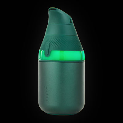 Puffco Proxy Core Kit in Pine, deep green, light ring lit, three-quarter view on a dark background