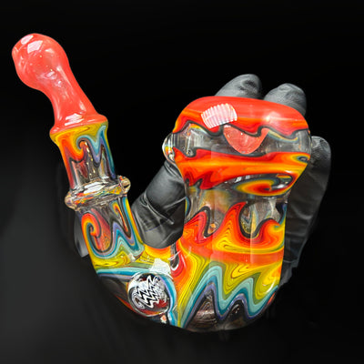 Sebastian Sherlock dry pipe by Seabass, fade to clear, mouthpiece up to the left and the black and white wig wag millie marble at the bend