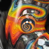 Close-up of the reversal spiral marble on the can, orange and yellow glass around it