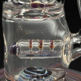 Close-up of the grid line perc, amber accents across the grid and a purple cap