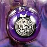 Close-up of the reversal marble on the body of the rig, with the maker's signature swirl at its centre