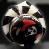 Close-up of the screaming ghost mask millie on the Pivot top, red, black and white under clear