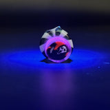 The Pivot top under blacklight, the clear over the millie glowing pink