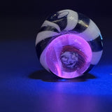 The Pivot top under blacklight, the clear over the millie glowing pink