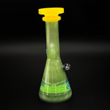 The back of the green mini tube with no joint in view, the marble in profile on the right and the band of color around the foot