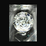 Close-up of the hand-pulled linework marble on the beaker, white line work over dark blue glass