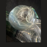 Close-up of the cabochon-style particle collider attachment, silver stringers lensed under clear