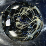 Close-up of the marble, silver stringers drawn into chaos over dark blue