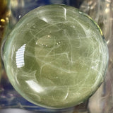Close-up of the green particle collider attachment, stringers lensed under clear