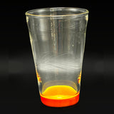 Wil Glass double layer cup, side profile, clear glass with carving and a Pomegranate red foot over Canary yellow