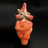 Zii goddess pipe, a sculpted red glass figure, seen from the front