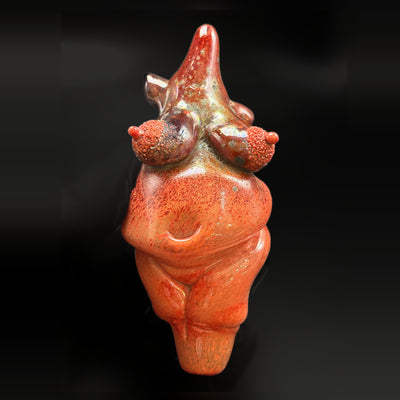 Zii goddess pipe, a sculpted red glass figure, seen from the front