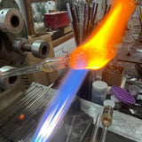 A glass tube blown out into a hollow form in the torch flame at the High Tide Santa Barbara studio, where the Intro to Hollow Glass class is taught