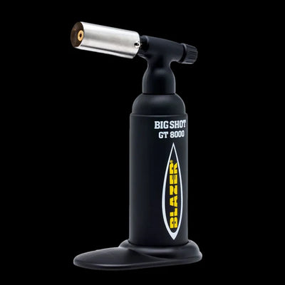 Blazer Big Shot GT8000 butane torch in black, upright on its base, against black.